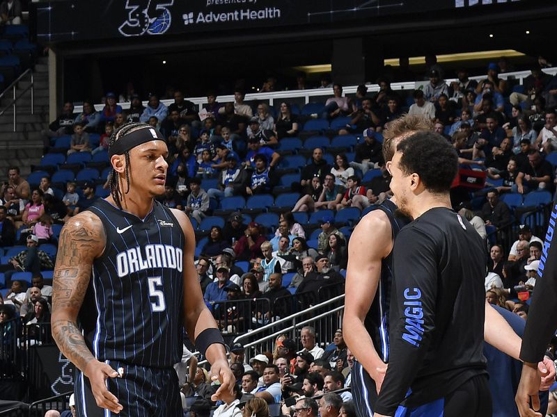 ORLANDO, FL - MARCH 19: Paolo Banchero #5 of the Orlando Magic high fives Cole Anthony #50 during the game against the Charlotte Hornets on March 19, 2024 at the Kia Center in Orlando, Florida. NOTE TO USER: User expressly acknowledges and agrees that, by downloading and or using this photograph, User is consenting to the terms and conditions of the Getty Images License Agreement. Mandatory Copyright Notice: Copyright 2024 NBAE (Photo by Fernando Medina/NBAE via Getty Images)