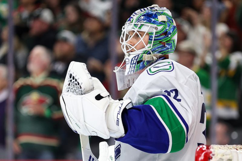 Dec 3, 2024; Saint Paul, Minnesota, USA; Vancouver Canucks goaltender Kevin Lankinen (32) reacts to Minnesota Wild defenseman Jake Middleton's (5) goal during the third period at Xcel Energy Center. Mandatory Credit: Matt Krohn-Imagn Images