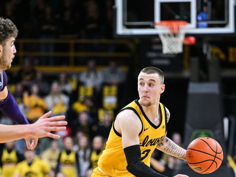 Dec 3, 2024; Iowa City, Iowa, USA; Iowa Hawkeyes guard Brock Harding (2) controls the ball against the Northwestern Wildcats during the second half at Carver-Hawkeye Arena. Mandatory Credit: Jeffrey Becker-Imagn Images