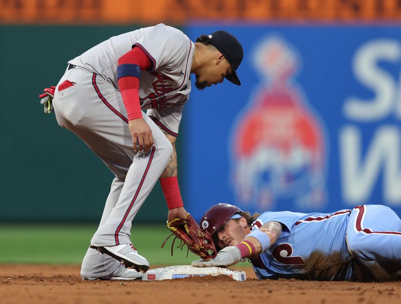 Aug 29, 2024; Philadelphia, Pennsylvania, USA; Philadelphia Phillies second base Bryson Stott (5) seals second base past Atlanta Braves shortstop Orlando Arcia (11) during the second inning at Citizens Bank Park. Mandatory Credit: Bill Streicher-USA TODAY Sports