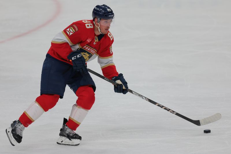 Mar 1, 2025; Sunrise, Florida, USA; Florida Panthers defenseman Nate Schmidt (88) moves the puck against the Calgary Flames during the second period at Amerant Bank Arena. Mandatory Credit: Sam Navarro-Imagn Images