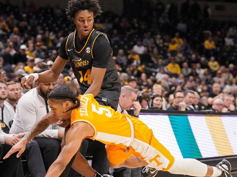 Feb 20, 2024; Columbia, Missouri, USA; Tennessee Volunteers guard Zakai Zeigler (5) looses the ball while dribbling as Missouri Tigers guard Anthony Robinson II (14) defends during the second half at Mizzou Arena. Mandatory Credit: Denny Medley-USA TODAY Sports