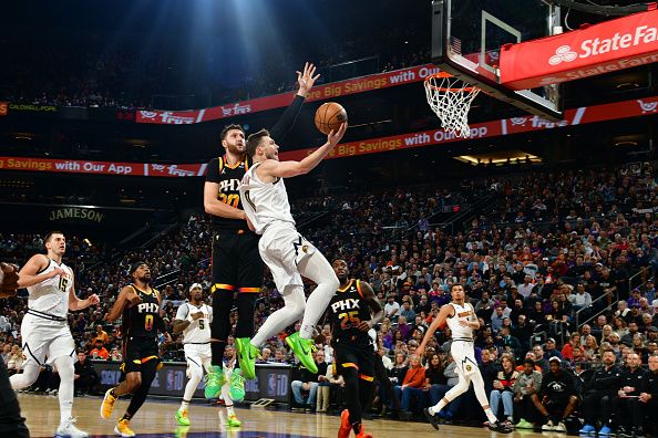 PHOENIX, AZ - DECEMBER 1: Christian Braun #0 of the Denver Nuggets drives to the basket during the game against the Phoenix Suns on December 1, 2023 at Footprint Center in Phoenix, Arizona. NOTE TO USER: User expressly acknowledges and agrees that, by downloading and or using this photograph, user is consenting to the terms and conditions of the Getty Images License Agreement. Mandatory Copyright Notice: Copyright 2023 NBAE (Photo by Kate Frese/NBAE via Getty Images)