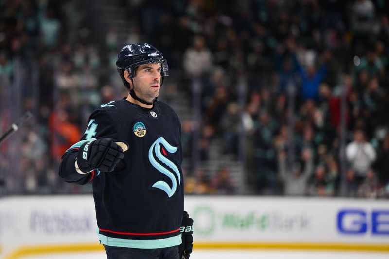 Feb 22, 2024; Seattle, Washington, USA; Seattle Kraken defenseman Justin Schultz (4) celebrates scoring a goal against the Vancouver Canucks during the second period at Climate Pledge Arena. Mandatory Credit: Steven Bisig-USA TODAY Sports