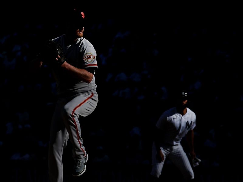 Apr 1, 2023; Bronx, New York, USA; New York Yankees right fielder Giancarlo Stanton (27) leads from first base as San Francisco Giants starting pitcher Alex Cobb (38) delivers a pitch during the first inning at Yankee Stadium. Mandatory Credit: Brad Penner-USA TODAY Sports