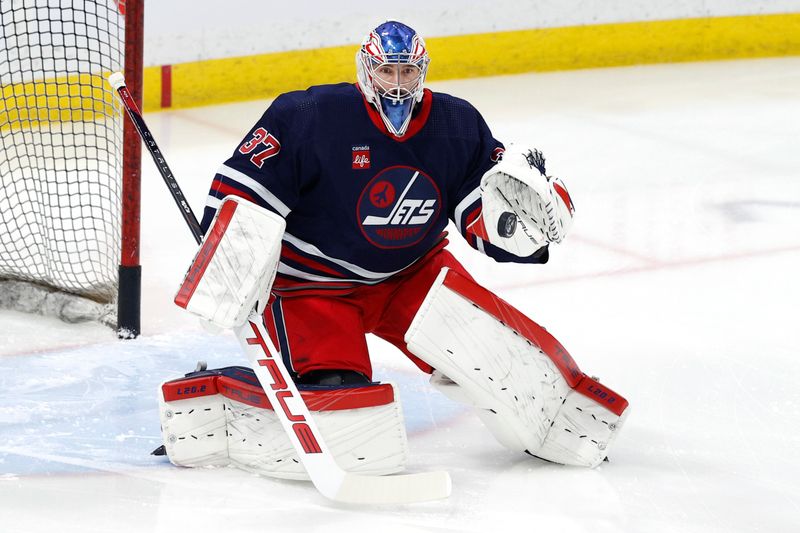 Mar 26, 2024; Winnipeg, Manitoba, CAN; Winnipeg Jets goaltender Connor Hellebuyck (37) warms up before a game against the Edmonton Oilers at Canada Life Centre. Mandatory Credit: James Carey Lauder-USA TODAY Sports