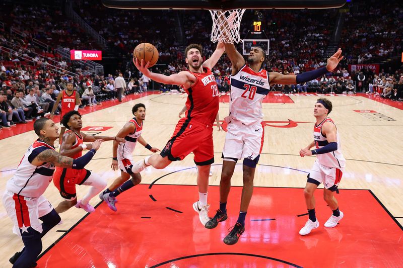HOUSTON, TEXAS - NOVEMBER 11: Alperen Sengun #28 of the Houston Rockets scores over Alexandre Sarr #20 of the Washington Wizards during the second half at Toyota Center on November 11, 2024 in Houston, Texas. NOTE TO USER: User expressly acknowledges and agrees that, by downloading and or using this photograph, User is consenting to the terms and conditions of the Getty Images License Agreement. (Photo by Alex Slitz/Getty Images)