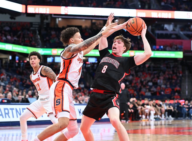 Dec 20, 2025; Syracuse, New York, USA; Northeastern Huskies guard William Kermoury (8) is closely defended by Syracuse Orange guard Nate Kingz (4) in the first half at the JMA Wireless Dome. Mandatory Credit: Mark Konezny-Imagn Images