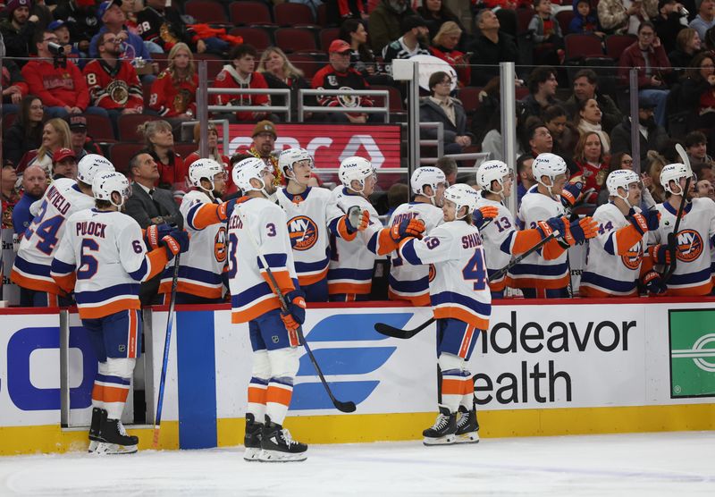 Dec 30, 2025; Chicago, Illinois, USA; The New York Islanders celebrate a first-period goal against the Chicago Blackhawks at United Center. Mandatory Credit: Talia Sprague-Imagn Images