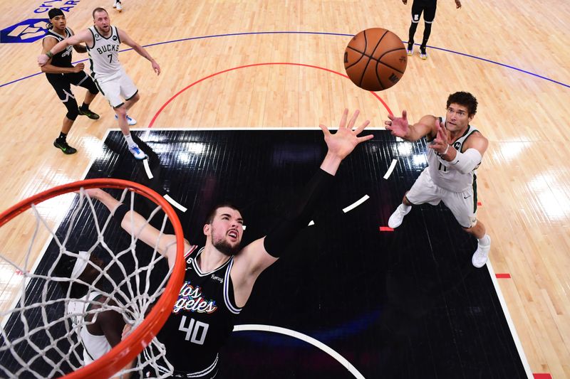 LOS ANGELES, CA - FEBRUARY 10: Brook Lopez #11 of the Milwaukee Bucks rebounds the ball during the game against the LA Clippers on February 10, 2023 at Crypto.Com Arena in Los Angeles, California. NOTE TO USER: User expressly acknowledges and agrees that, by downloading and/or using this Photograph, user is consenting to the terms and conditions of the Getty Images License Agreement. Mandatory Copyright Notice: Copyright 2023 NBAE (Photo by Adam Pantozzi/NBAE via Getty Images)