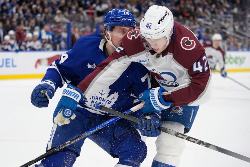 Jan 25, 2026; Toronto, Ontario, CAN; Colorado Avalanche defenseman Josh Manson (42) and Toronto Maple Leafs forward Bobby McMann (74) battle for position during the third period at Scotiabank Arena. Mandatory Credit: John E. Sokolowski-Imagn Images