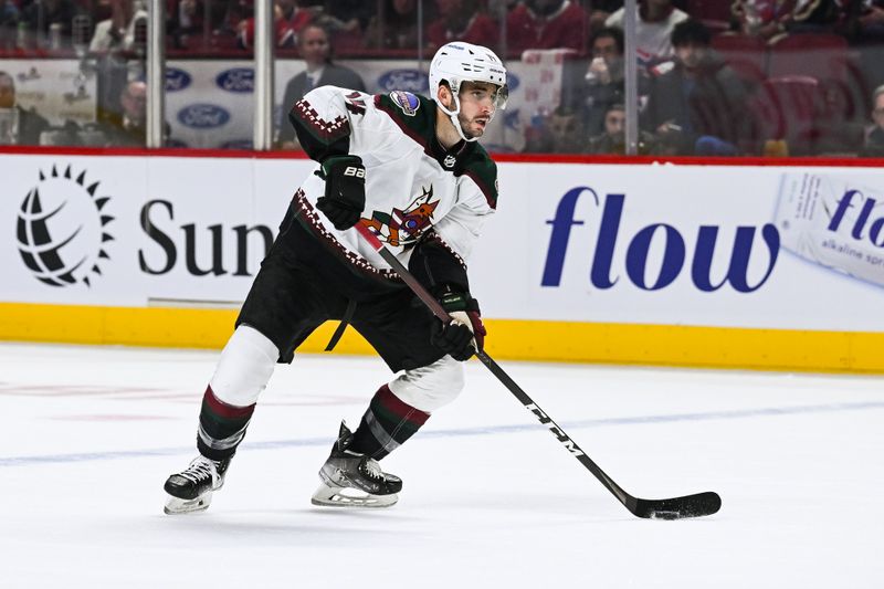 Oct 20, 2022; Montreal, Quebec, CAN; Arizona Coyotes defenseman Shayne Gostisbehere (14) plays the puck against the Montreal Canadiens during the second period at Bell Centre. Mandatory Credit: David Kirouac-USA TODAY Sports