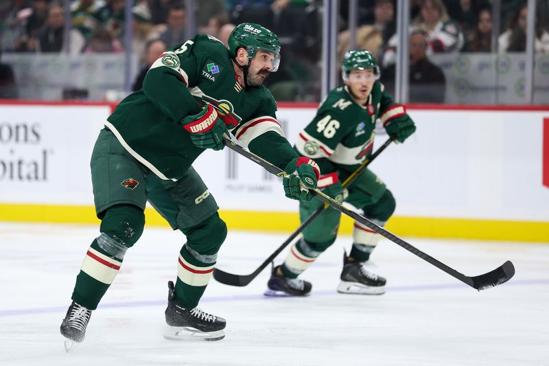 Oct 26, 2025; Saint Paul, Minnesota, USA; Minnesota Wild defenseman Jake Middleton (5) shoots the puck against the San Jose Sharks during the third period at Grand Casino Arena. Mandatory Credit: Matt Krohn-Imagn Images