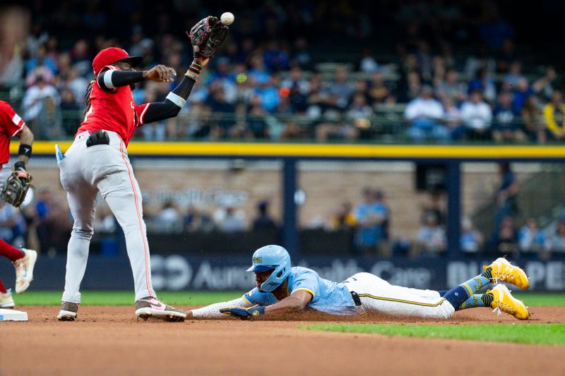 Aug 9, 2024; Milwaukee, Wisconsin, USA;  Milwaukee Brewers right fielder Jackson Chourio (11) steals second base as Cincinnati Reds shortstop Elly De La Cruz (44) fields the throw during the first inning inning at American Family Field. Mandatory Credit: Jeff Hanisch-USA TODAY Sports