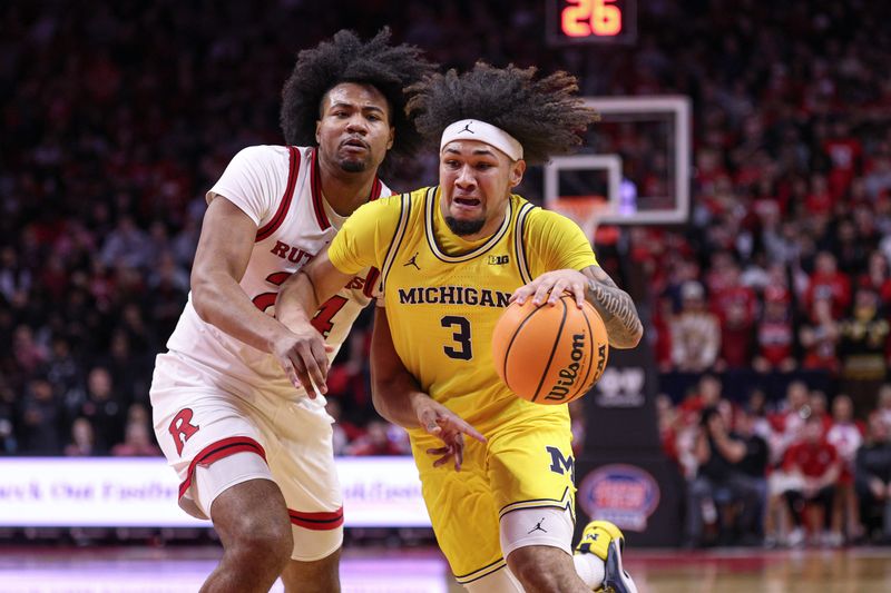 Feb 1, 2025; Piscataway, New Jersey, USA; Michigan Wolverines guard Tre Donaldson (3) dribbles against Rutgers Scarlet Knights center Lathan Sommerville (24) during the first half at Jersey Mike's Arena. Mandatory Credit: Vincent Carchietta-Imagn Images