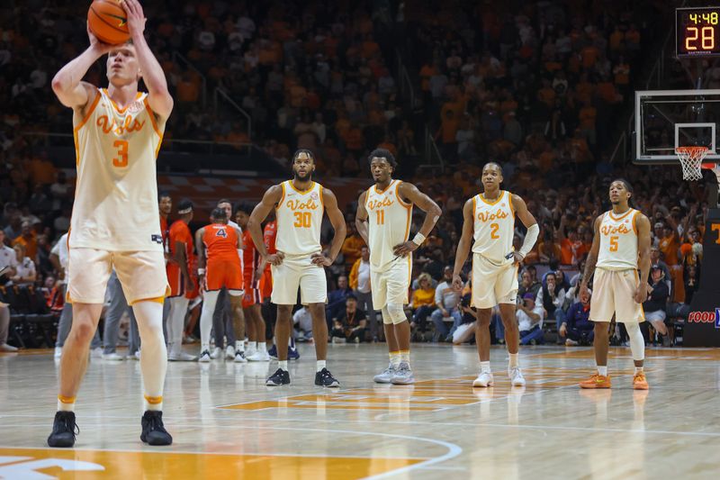 Feb 28, 2024; Knoxville, Tennessee, USA; Tennessee Volunteers guard Josiah-Jordan James (30) and forward Tobe Awaka (11) and guard Jordan Gainey (2) and guard Zakai Zeigler (5) watch as guard Dalton Knecht (3) shoots free throws against the Auburn Tigers during the second half at Thompson-Boling Arena at Food City Center. Mandatory Credit: Randy Sartin-USA TODAY Sports