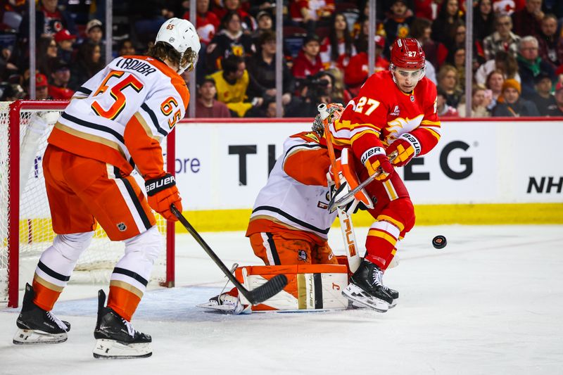 Jan 25, 2026; Calgary, Alberta, CAN; Calgary Flames right wing Matt Coronato (27) screens in front of Anaheim Ducks goaltender Lukas Dostal (1) during the second period at Scotiabank Saddledome. Mandatory Credit: Sergei Belski-Imagn Images