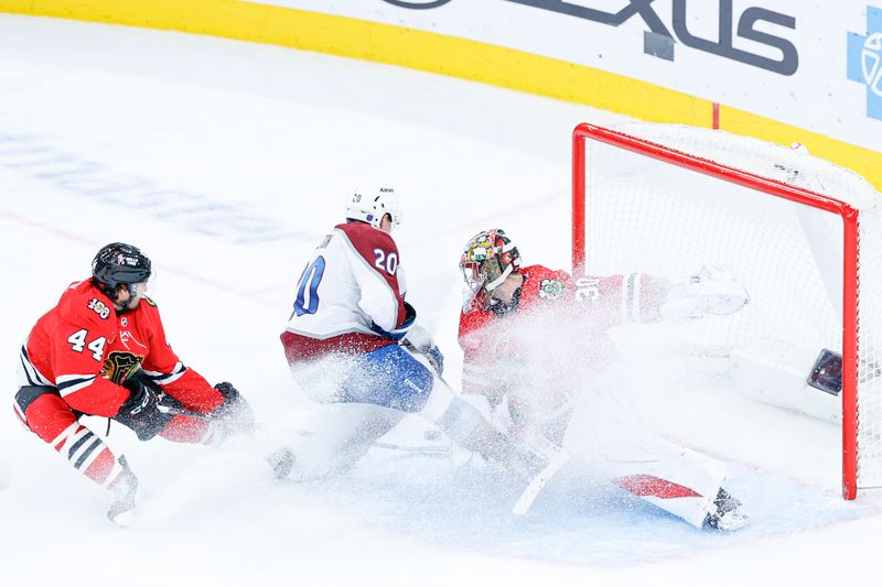 Nov 23, 2025; Chicago, Illinois, USA; Chicago Blackhawks goaltender Spencer Knight (30) defends against Colorado Avalanche center Ross Colton (20) during the third period at United Center. Mandatory Credit: Kamil Krzaczynski-Imagn Images