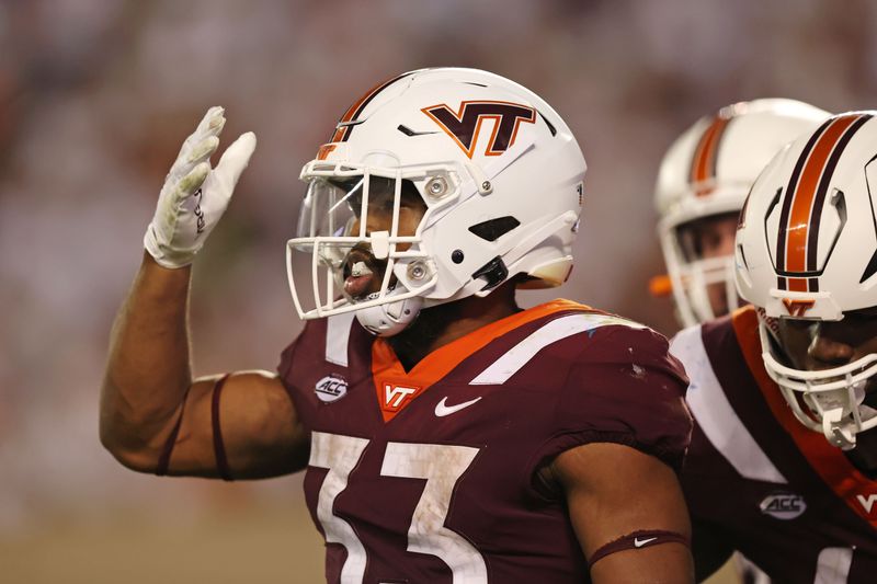 Sep 30, 2023; Blacksburg, Virginia, USA; Virginia Tech Hokies running back Bhayshul Tuten (33) celebrates after scoring a touchdown during the second quarter against the Pittsburgh Panthers at Lane Stadium. Mandatory Credit: Peter Casey-USA TODAY Sports