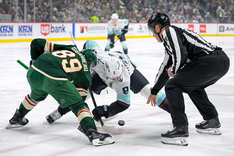 Mar 19, 2025; Saint Paul, Minnesota, USA;  Minnesota Wild forward Frederick Gaudreau (89) and Seattle Kraken defenseman Cale Fleury (8) face-off during the first period at Xcel Energy Center. Mandatory Credit: Nick Wosika-Imagn Images