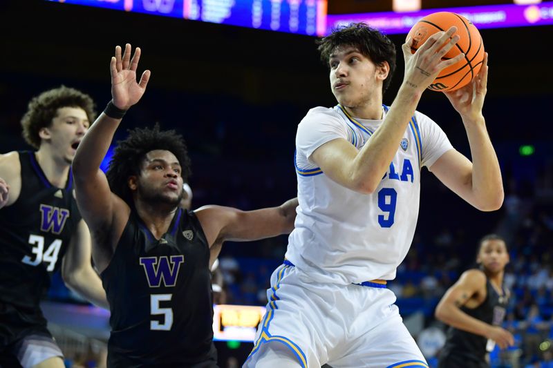 January 14, 2024; Los Angeles, California, USA; UCLA Bruins forward Berke Buyuktuncel (9) controls the ball against Washington Huskies guard Sahvir Wheeler (5) during the second half at Pauley Pavilion. Mandatory Credit: Gary A. Vasquez-USA TODAY Sports