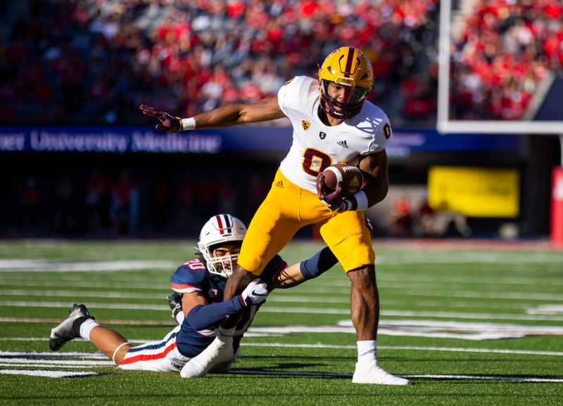 Nov 25, 2022; Tucson, Arizona, USA; Arizona State Sun Devils wide receiver Charles Hall IV (0) is tackled by Arizona Wildcats cornerback Treydan Stukes (20) during the Territorial Cup at Arizona Stadium. Mandatory Credit: Mark J. Rebilas-USA TODAY Sports