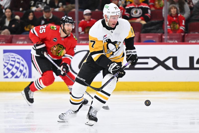 Feb 15, 2024; Chicago, Illinois, USA; Pittsburgh Penguins forward Jeff Carter (77) gains control of a loose puck in the second period against the Chicago Blackhawks at United Center. Mandatory Credit: Jamie Sabau-USA TODAY Sports