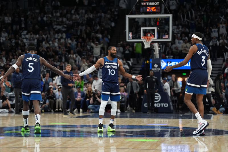 MINNEAPOLIS, MN -  OCTOBER 22: Anthony Edwards #5,  Jaden McDaniels #3 and Mike Conley #10 of the Minnesota Timberwolves high five during the game against the Toronto Raptors on October 22, 2024 at Target Center in Minneapolis, Minnesota. NOTE TO USER: User expressly acknowledges and agrees that, by downloading and or using this Photograph, user is consenting to the terms and conditions of the Getty Images License Agreement. Mandatory Copyright Notice: Copyright 2024 NBAE (Photo by Jordan Johnson/NBAE via Getty Images)