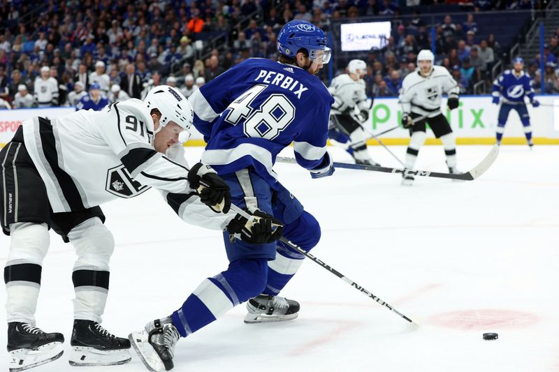 Jan 9, 2024; Tampa, Florida, USA; Los Angeles Kings right wing Carl Grundstrom (91) defends Tampa Bay Lightning defenseman Nick Perbix (48) during the first period at Amalie Arena. Mandatory Credit: Kim Klement Neitzel-USA TODAY Sports