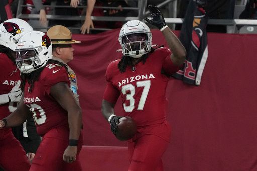 Arizona Cardinals running back Tony Jones Jr. (37) celebrates his touchdown run against the San Francisco 49ers during the second half of an NFL football game in Glendale, Ariz., Sunday, Jan. 5, 2025. (AP Photo/Rick Scuteri)