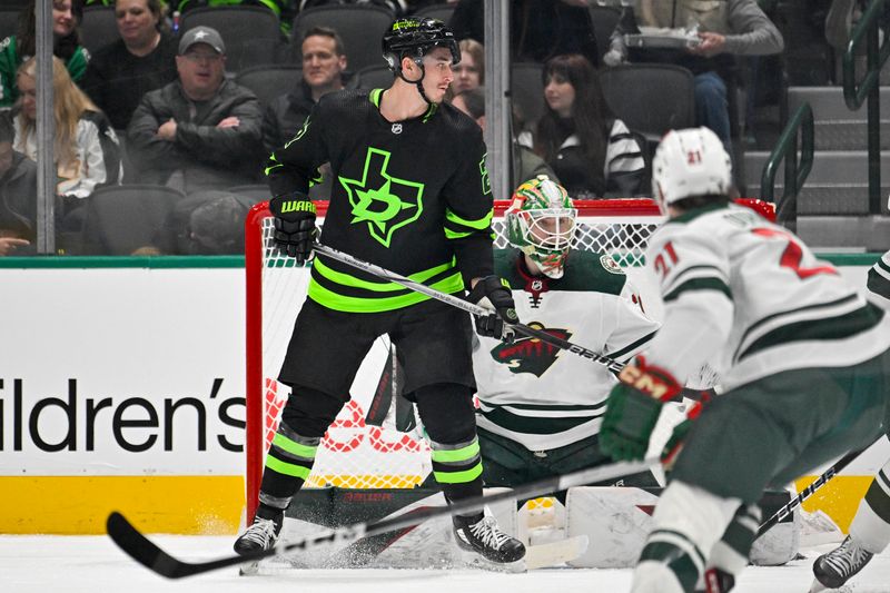 Jan 10, 2024; Dallas, Texas, USA; Dallas Stars left wing Mason Marchment (27) screens Minnesota Wild goaltender Jesper Wallstedt (30) during the first period at the American Airlines Center. Mandatory Credit: Jerome Miron-USA TODAY Sports