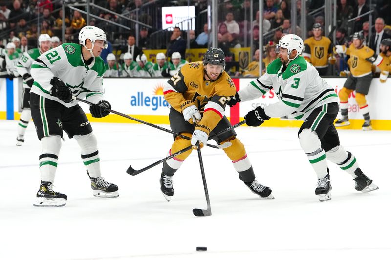 Dec 6, 2024; Las Vegas, Nevada, USA; Dallas Stars left wing Jason Robertson (21) and Dallas Stars defenseman Mathew Dumba (3) check Vegas Golden Knights defenseman Shea Theodore (27) during the second period at T-Mobile Arena. Mandatory Credit: Stephen R. Sylvanie-Imagn Images