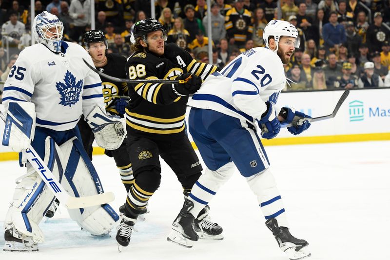 May 4, 2024; Boston, Massachusetts, USA; Boston Bruins right wing David Pastrnak (88) battles with Toronto Maple Leafs defenseman Joel Edmundson (20) in front of goaltender Ilya Samsonov (35) during the first period in game seven of the first round of the 2024 Stanley Cup Playoffs at TD Garden. Mandatory Credit: Bob DeChiara-USA TODAY Sports