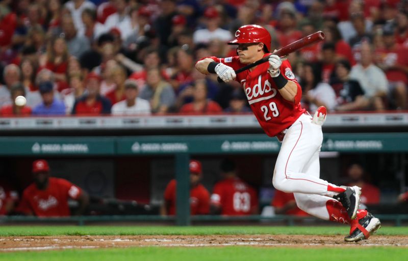 Aug 16, 2023; Cincinnati, Ohio, USA; Cincinnati Reds center fielder TJ Friedl (29) reaches on a bunt single against the Cleveland Guardians during the sixth inning at Great American Ball Park. Mandatory Credit: David Kohl-USA TODAY Sports