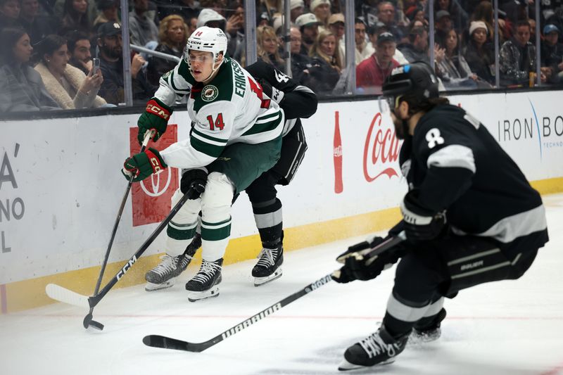 Jan 3, 2026; Los Angeles, California, USA;  Minnesota Wild center Joel Eriksson Ek (14) fights for the puck against Los Angeles Kings defenseman Mikey Anderson (44) and defenseman Drew Doughty (8) during the third period at Crypto.com Arena. Mandatory Credit: Kiyoshi Mio-Imagn Images