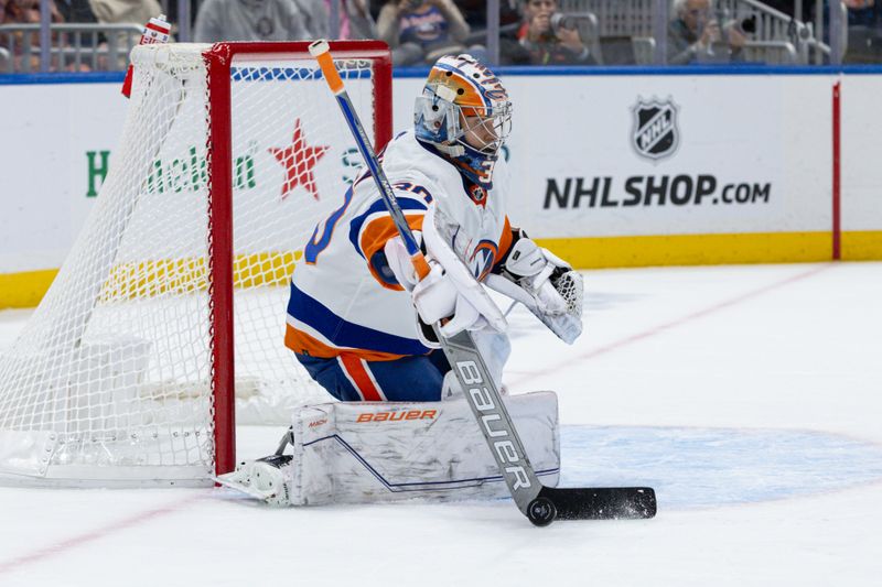 Oct 30, 2023; Elmont, New York, USA; New York Islanders goaltender Ilya Sorokin (30) controls the puck against the Detroit Red Wings during the first period at UBS Arena. Mandatory Credit: Thomas Salus-USA TODAY Sports