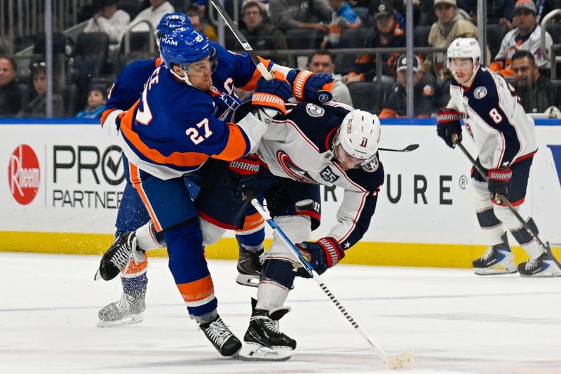 Nov 2, 2025; Elmont, New York, USA;  New York Islanders left wing Anders Lee (27) and Columbus Blue Jackets left wing Miles Wood (11) collide at center ice during the second period at UBS Arena. Mandatory Credit: Dennis Schneidler-Imagn Images