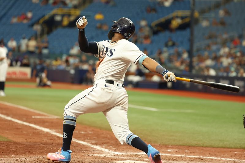 Sep 21, 2023; St. Petersburg, Florida, USA; Tampa Bay Rays center fielder Manuel Margot (13) hits the game winning RBI during the ninth inning against the Los Angeles Angels at Tropicana Field. Mandatory Credit: Kim Klement Neitzel-USA TODAY Sports