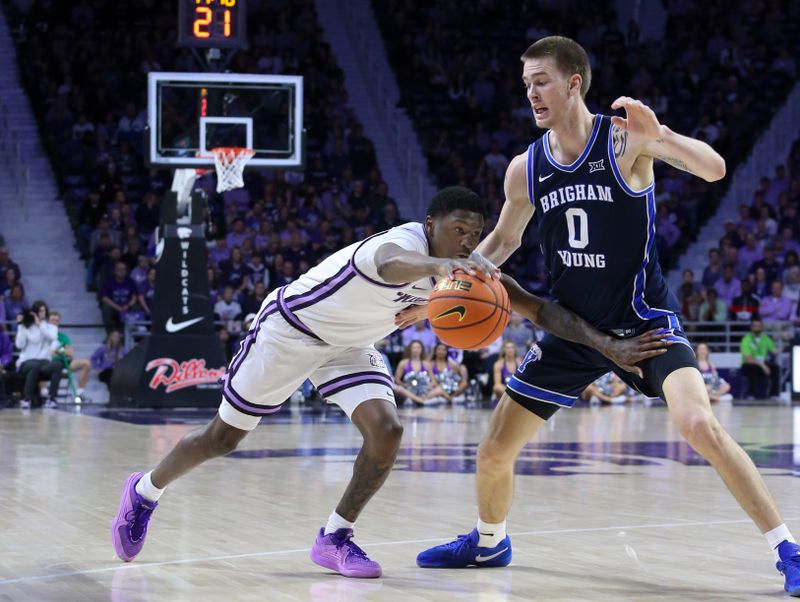 Feb 24, 2024; Manhattan, Kansas, USA; Kansas State Wildcats guard Cam Carter (5) dribbles against Brigham Young Cougars forward Noah Waterman (0) during the first half at Bramlage Coliseum. Mandatory Credit: Scott Sewell-USA TODAY Sports