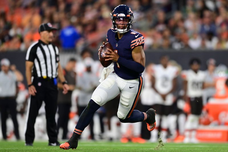 Chicago Bears quarterback Justin Fields (1) scrambles against the Cleveland Browns during the first half of an NFL preseason football game, Saturday, Aug. 27, 2022, in Cleveland. (AP Photo/David Dermer)