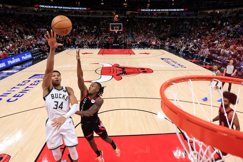 CHICAGO, ILLINOIS - NOVEMBER 30: Giannis Antetokounmpo #34 of the Milwaukee Bucks takes a shot over Ayo Dosunmu #12 of the Chicago Bulls during the second half at the United Center on November 30, 2023 in Chicago, Illinois. NOTE TO USER: User expressly acknowledges and agrees that, by downloading and or using this photograph, User is consenting to the terms and conditions of the Getty Images License Agreement. (Photo by Justin Casterline/Getty Images)