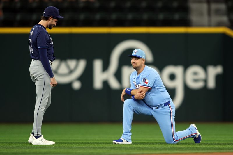 Jul 7, 2024; Arlington, Texas, USA; Tampa Bay Rays right fielder Josh Lowe (15) and Texas Rangers first base Nathaniel Lowe (30) talk on the field before the game at Globe Life Field. Mandatory Credit: Tim Heitman-USA TODAY Sports