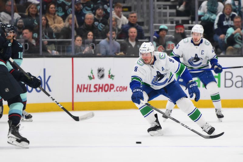 Nov 24, 2023; Seattle, Washington, USA; Vancouver Canucks center J.T. Miller (9) tries to intercept a Seattle Kraken pass during the first period at Climate Pledge Arena. Mandatory Credit: Steven Bisig-USA TODAY Sports