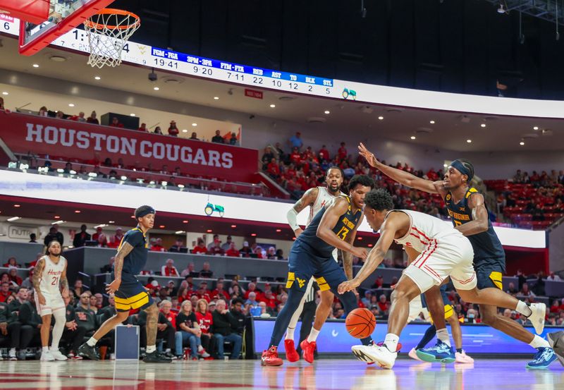 Jan 15, 2025; Houston, Texas, USA;  Houston Cougars guard L.J. Cryer (4) dribbles again st West Virginia Mountaineers forward Amani Hansberry (13) in the second half at Fertitta Center. Mandatory Credit: Thomas Shea-Imagn Images