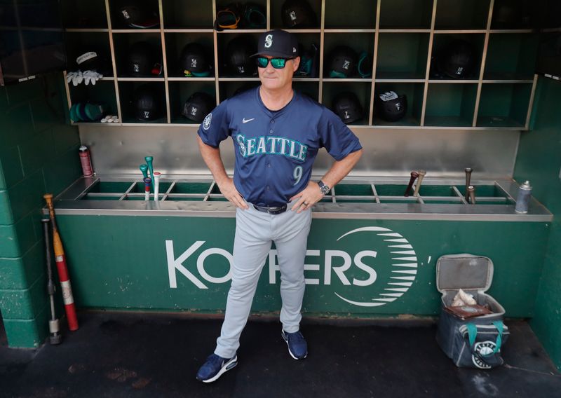 Aug 18, 2024; Pittsburgh, Pennsylvania, USA;  Seattle Mariners manager Scott Servais (9) looks on from the dugout before the game against the Pittsburgh Pirates at PNC Park. Mandatory Credit: Charles LeClaire-USA TODAY Sports