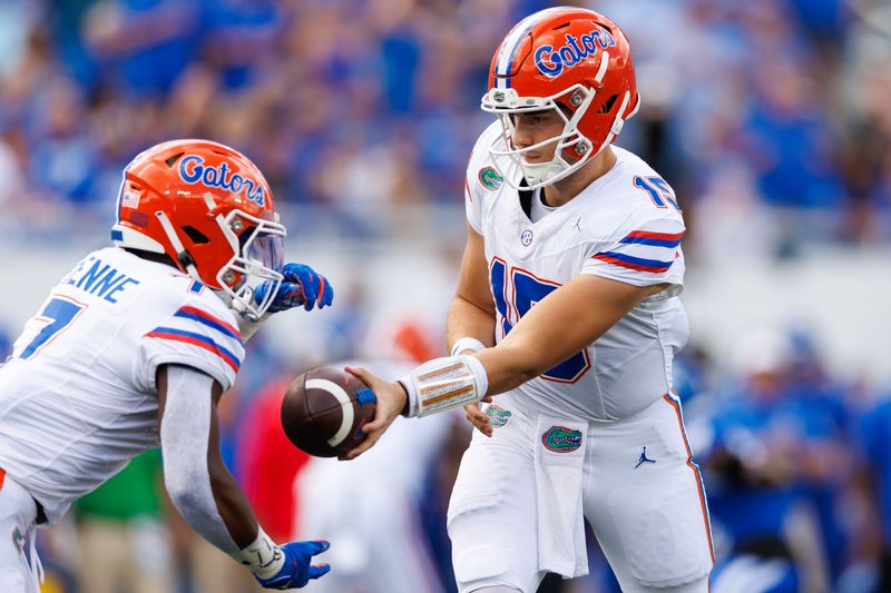 Sep 30, 2023; Lexington, Kentucky, USA; Florida Gators quarterback Graham Mertz (15) hands the ball to Florida Gators running back Trevor Etienne (7) during the first quarter against the Kentucky Wildcats at Kroger Field. Mandatory Credit: Jordan Prather-USA TODAY Sports