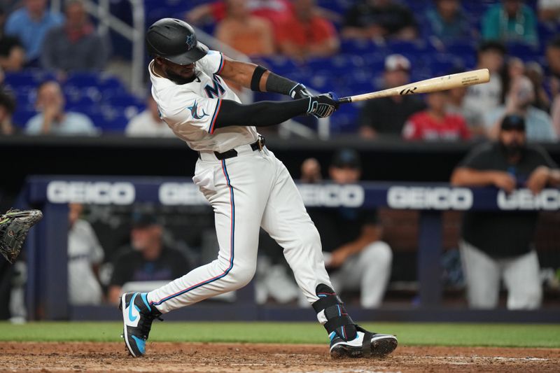 Apr 2, 2024; Miami, Florida, USA; Miami Marlins left fielder Bryan De La Cruz (14) hits a home run in the ninth inning against the Los Angeles Angels at loanDepot Park. Mandatory Credit: Jim Rassol-USA TODAY Sports