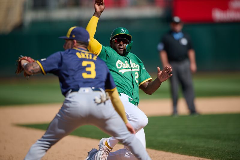 Aug 24, 2024; Oakland, California, USA; Oakland Athletics outfielder Daz Cameron (28) slides into third base against Milwaukee Brewers infielder Joey Ortiz (3) during the ninth inning at Oakland-Alameda County Coliseum. Mandatory Credit: Robert Edwards-USA TODAY Sports