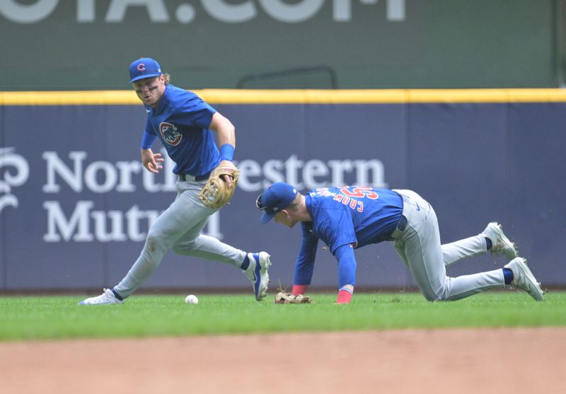 Jun 29, 2024; Milwaukee, Wisconsin, USA; Chicago Cubs outfielder Pete Crow-Armstrong (52) and Chicago Cubs second base Nico Hoerner (2) can’t field a fly ball against the Milwaukee Brewers in the third inning at American Family Field. Mandatory Credit: Michael McLoone-USA TODAY Sports