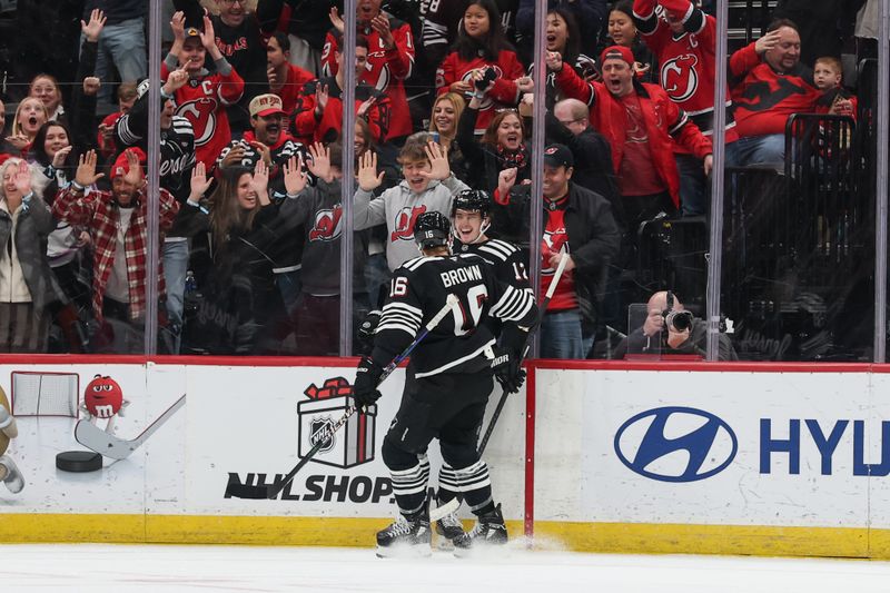 Nov 24, 2025; Newark, New Jersey, USA; New Jersey Devils center Cody Glass (12) celebrates his goal against the Detroit Red Wings during the first period at Prudential Center. Mandatory Credit: Ed Mulholland-Imagn Images